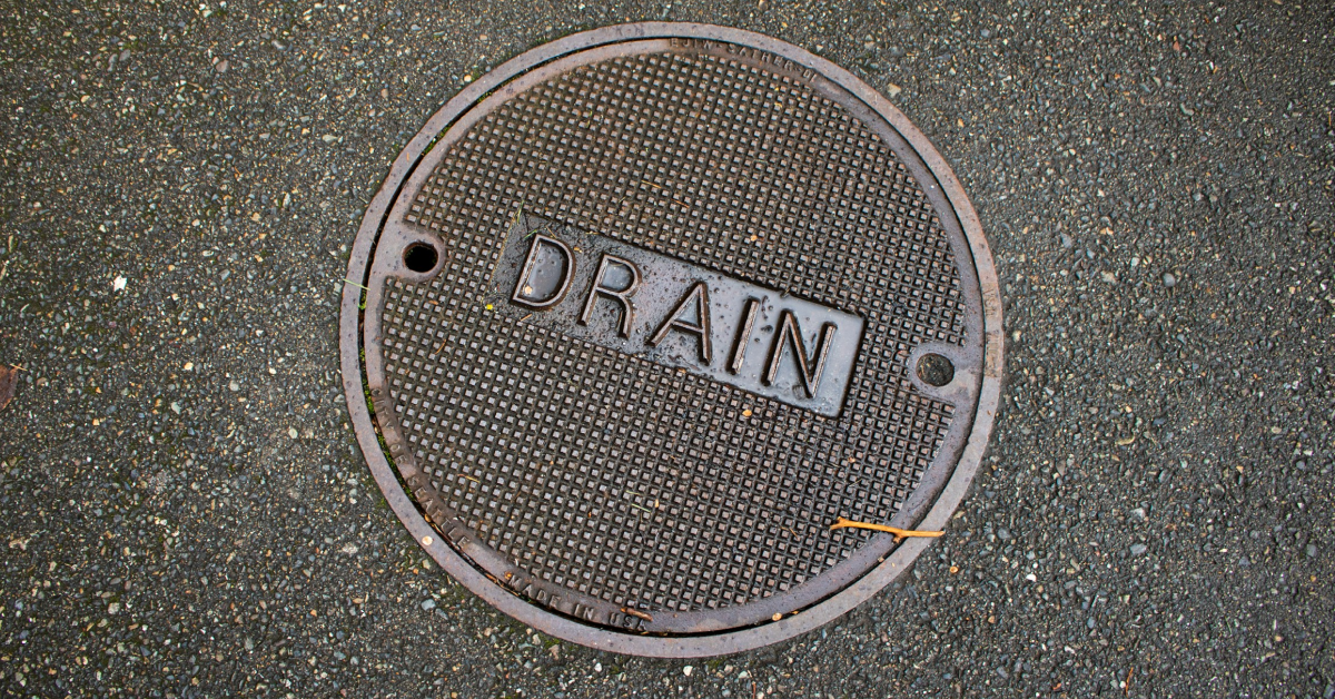 Plumber inspecting a blocked household drain